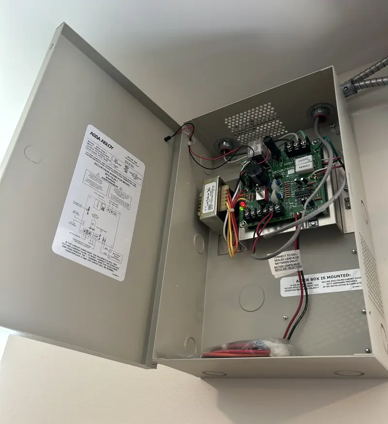 Access control power supply box open on a wall