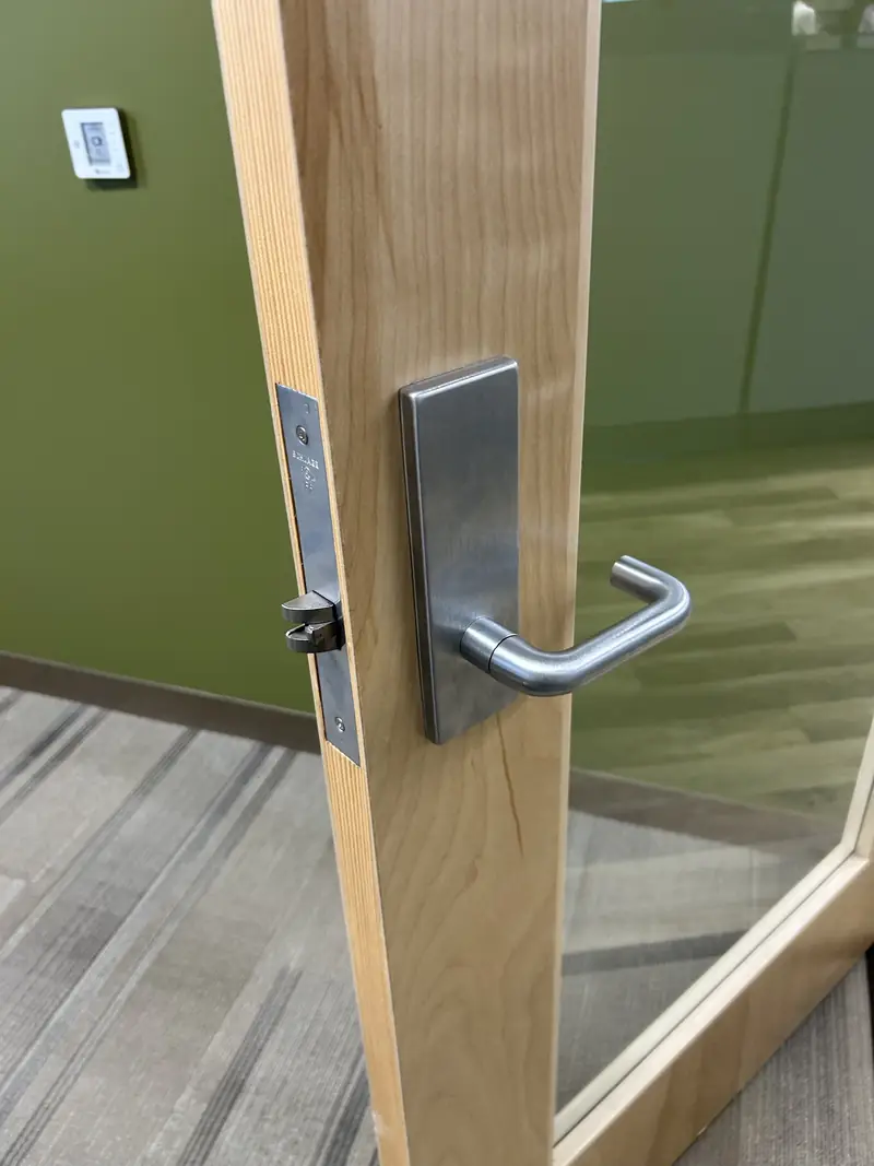 Commercial mortise lock with lever handle on an office door