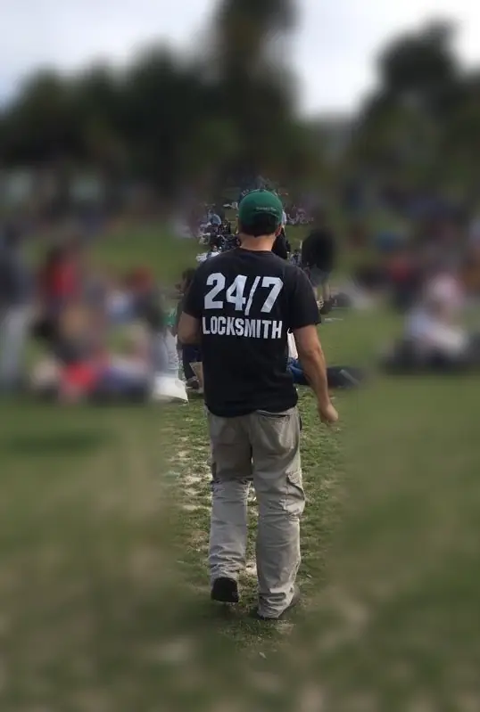 Our technician in a 24/7 Locksmith shirt in a San Francisco park